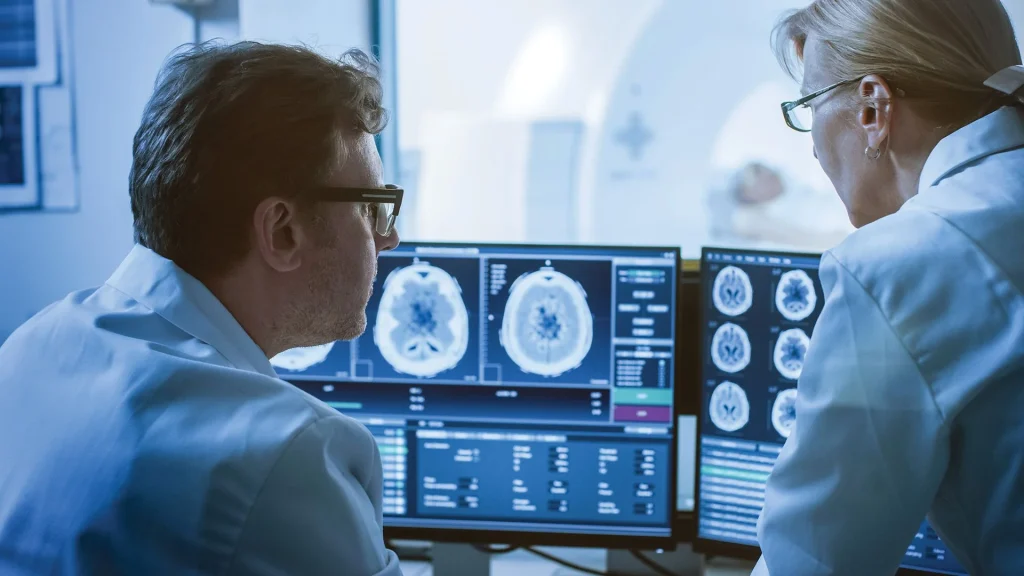 radiologist on their computers looking at data